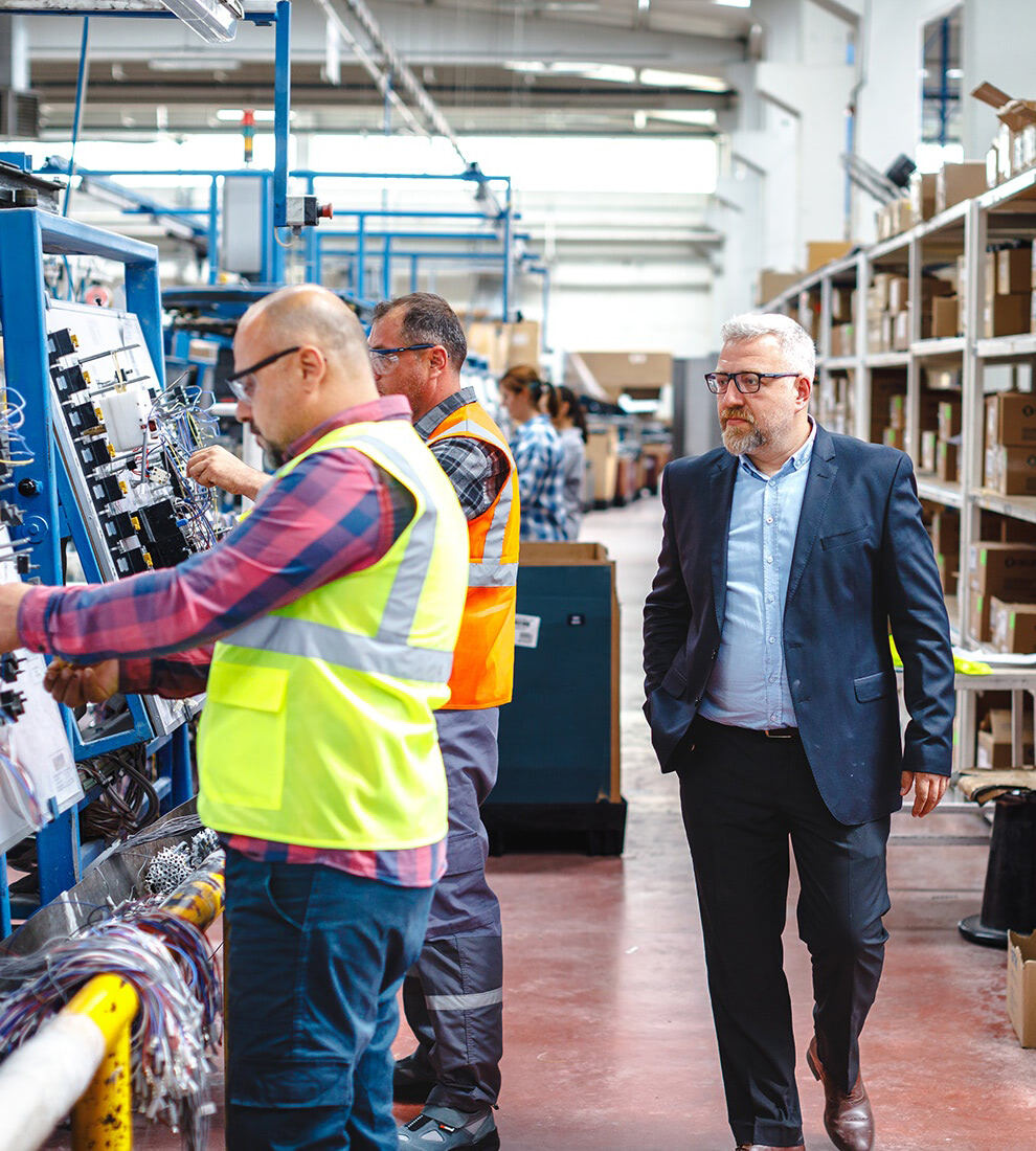 factory-manager-inspecting-production-workers