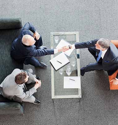 shaking-hands-across-coffee-table