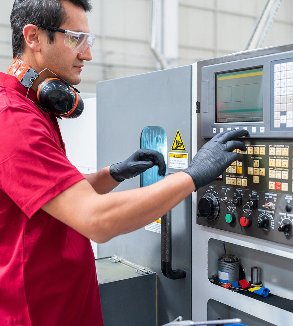 man-operating-cnc-machine-control-panel