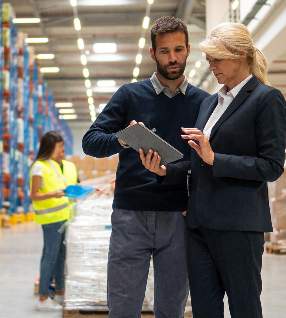 warehouse-managers-reviewing-tablet-data